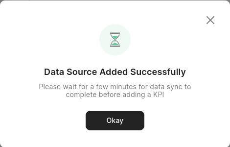 Screenshot of a pop-up modal with the title &quot;Data Source Added Successfully&quot; and a line of text below it saying &quot;Please wait for a few minutes for data sync to complete before adding a KPI&quot;.